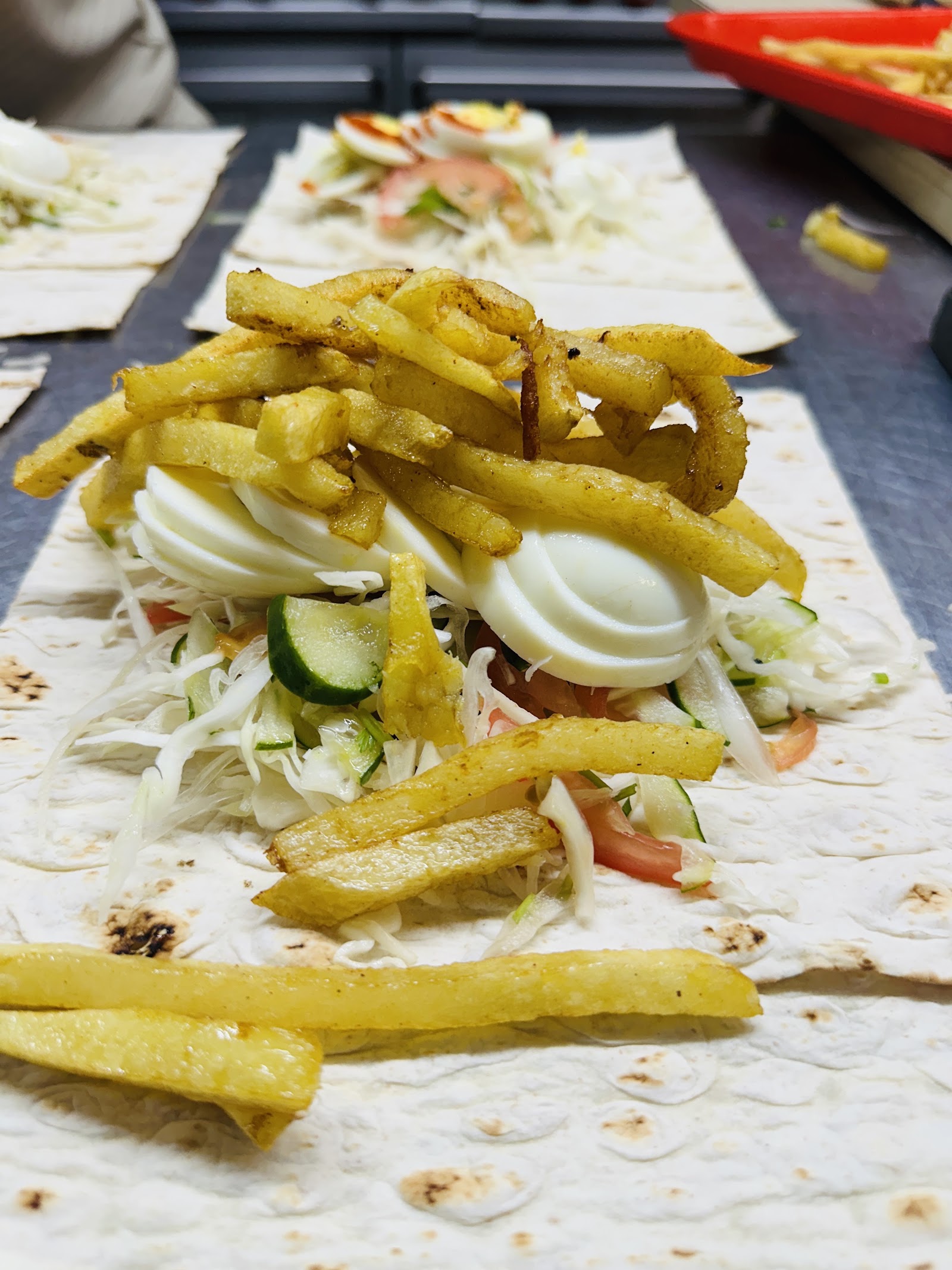 Loaded wrap with seasoned fries and fresh vegetables
